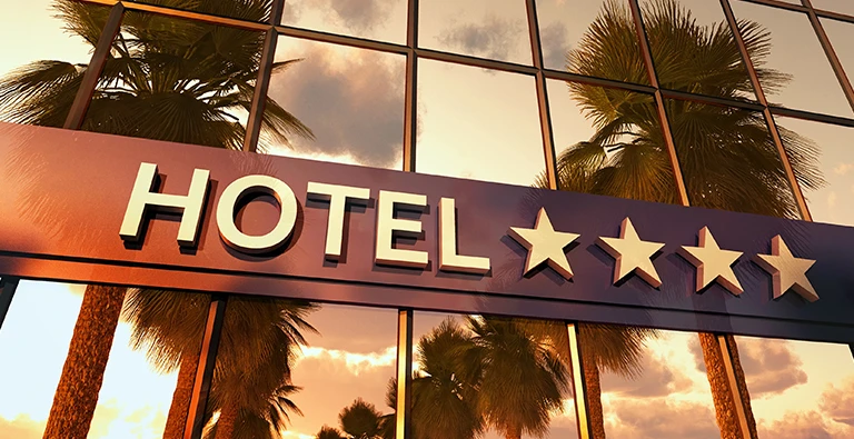 Hotel logo and brand identity displayed across signage, website, and stationery, illustrating cohesive hotel branding.
