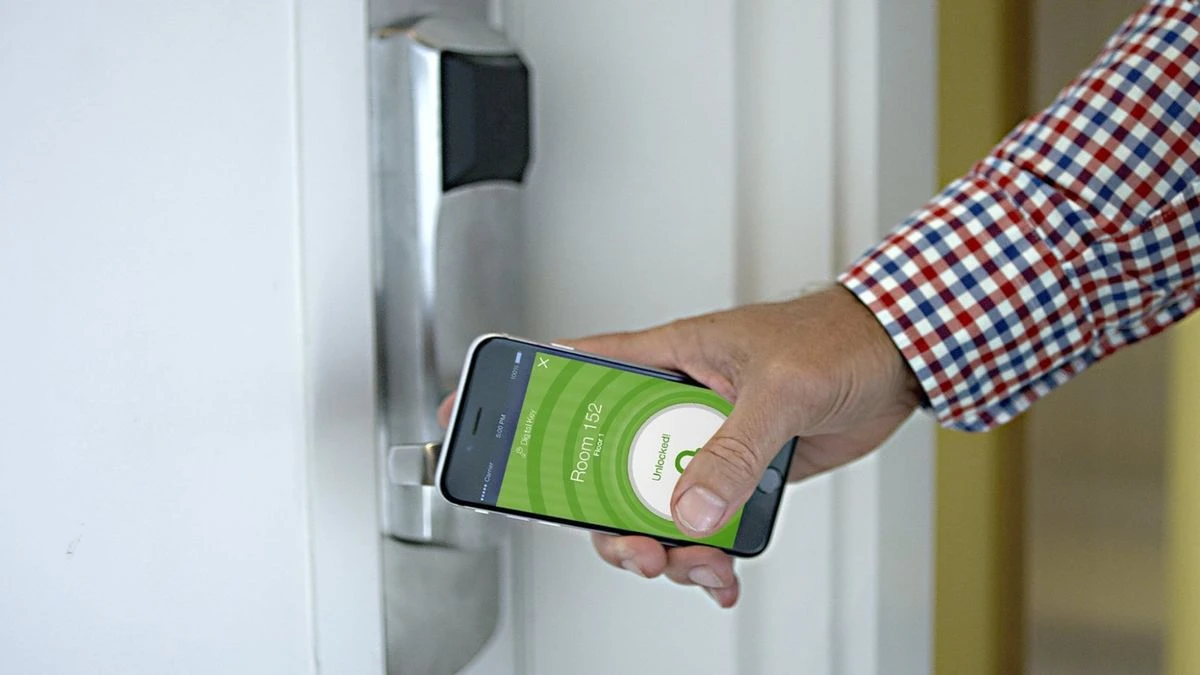 a person holding a phone to open a door