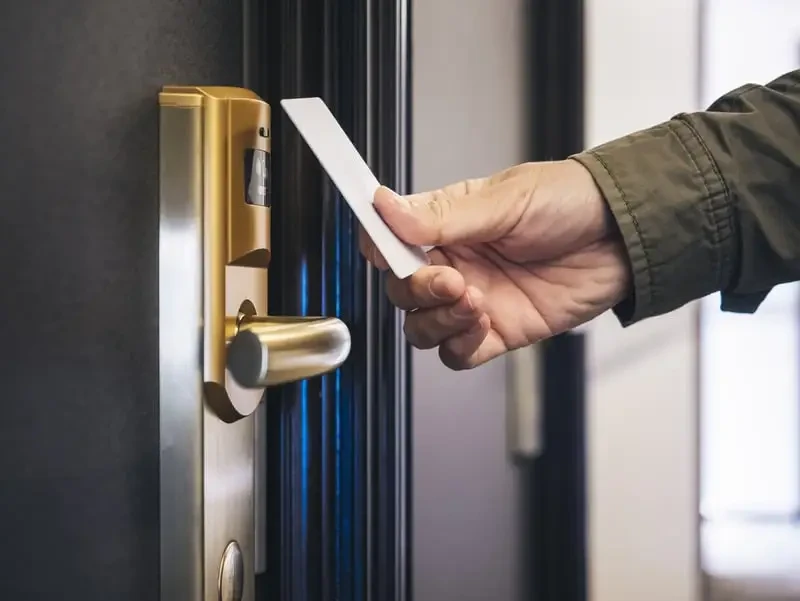 Modern RFID card unlocking a hotel room door, showcasing the convenience of a Hotel Key Card system.